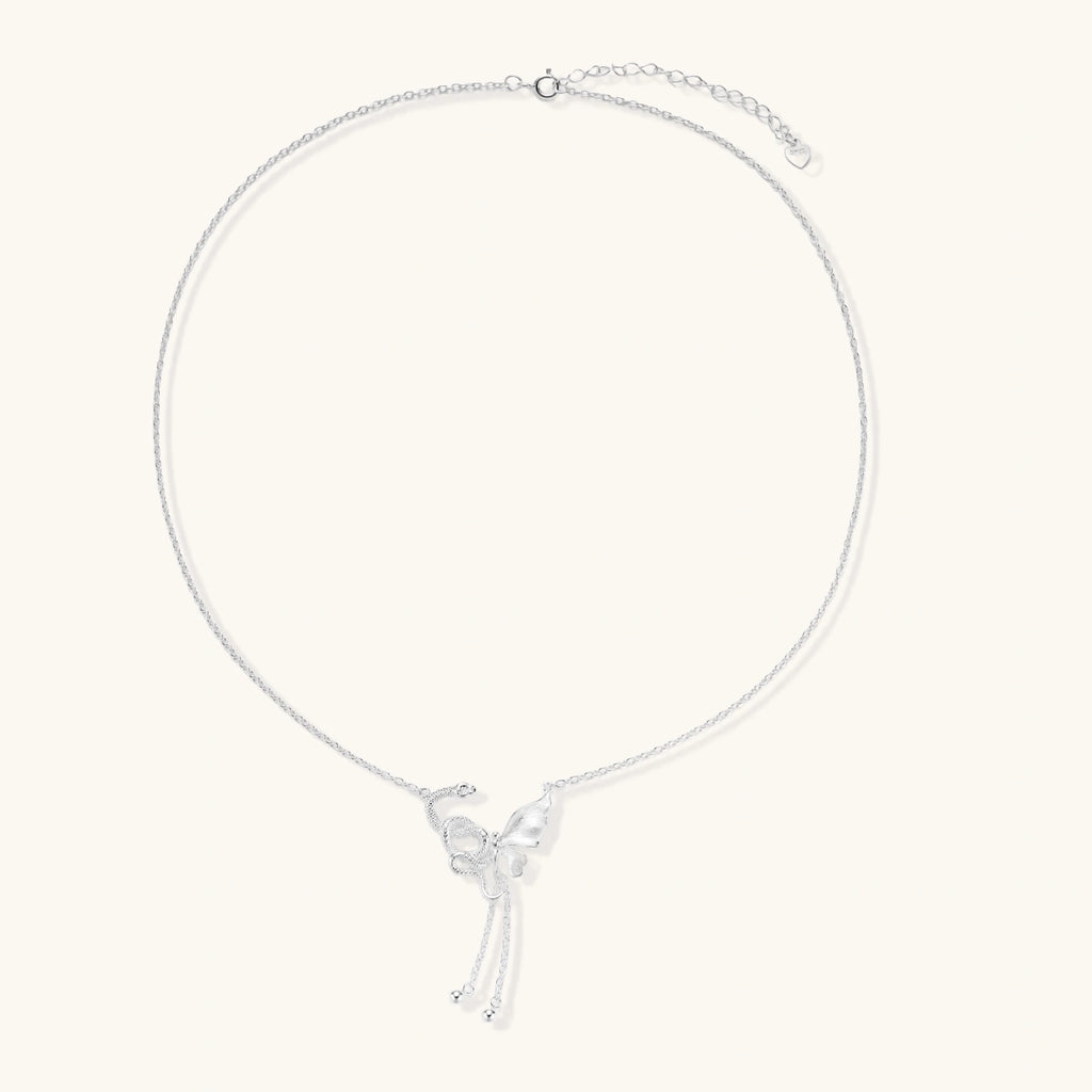Sterling silver butterfly pendant with textured wing detail on adjustable Y-chain with ball drop ends